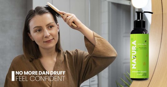 Confident woman using comb with NAJURA Anti-Dandruff Shampoo in background, promoting dandruff-free, healthy scalp